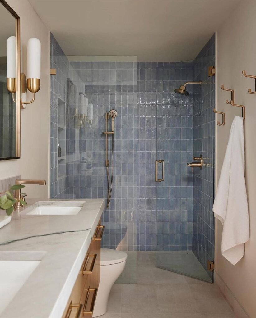 Elegant Blue-Tiled Bathroom with Gold Accents
