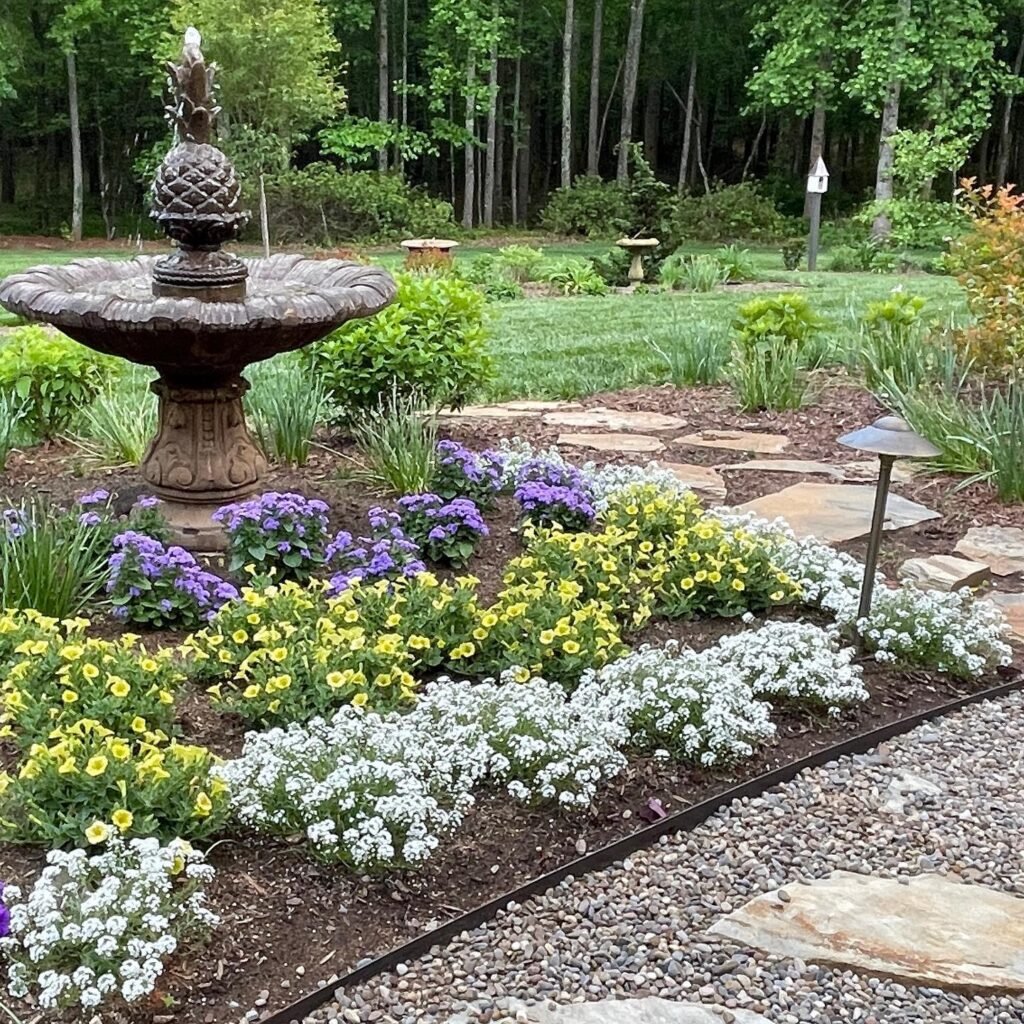 Elegant Garden Fountain with Vibrant Flower Bed
